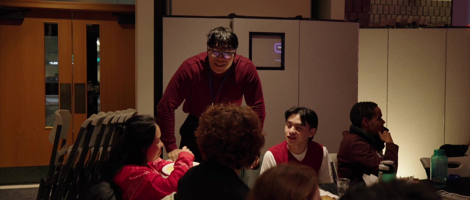 A facilitator leaning in at the end of a table