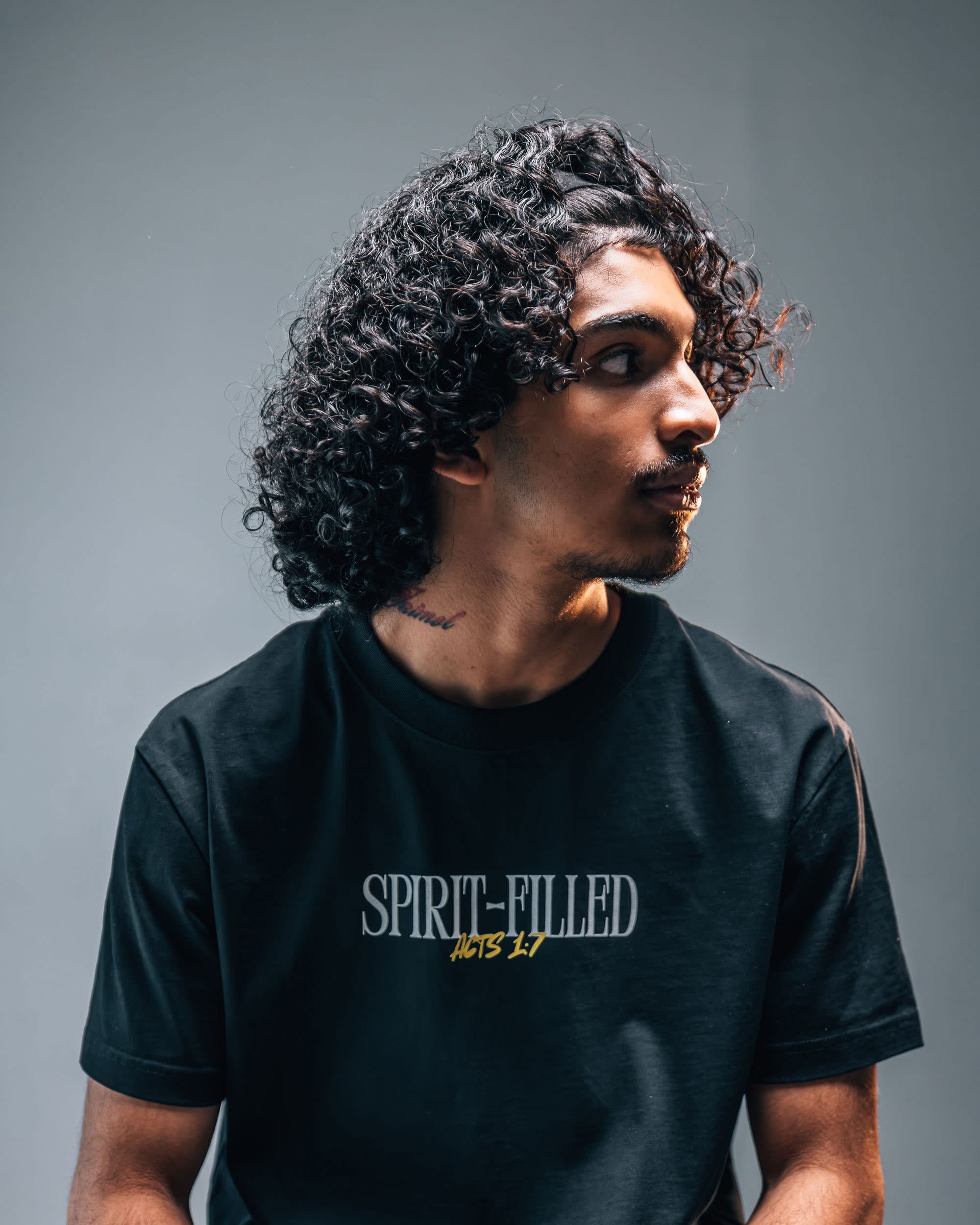 The black Spirit-Filled tee worn, chest wordmark